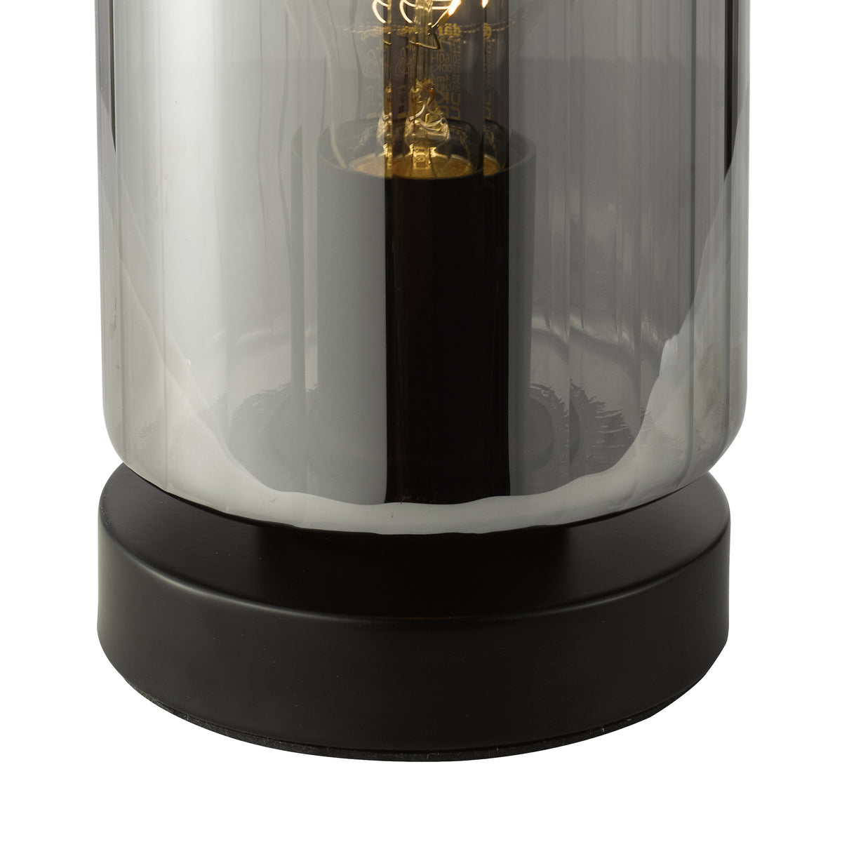 Close up of a table lamp with a black base and a smoked glass shade