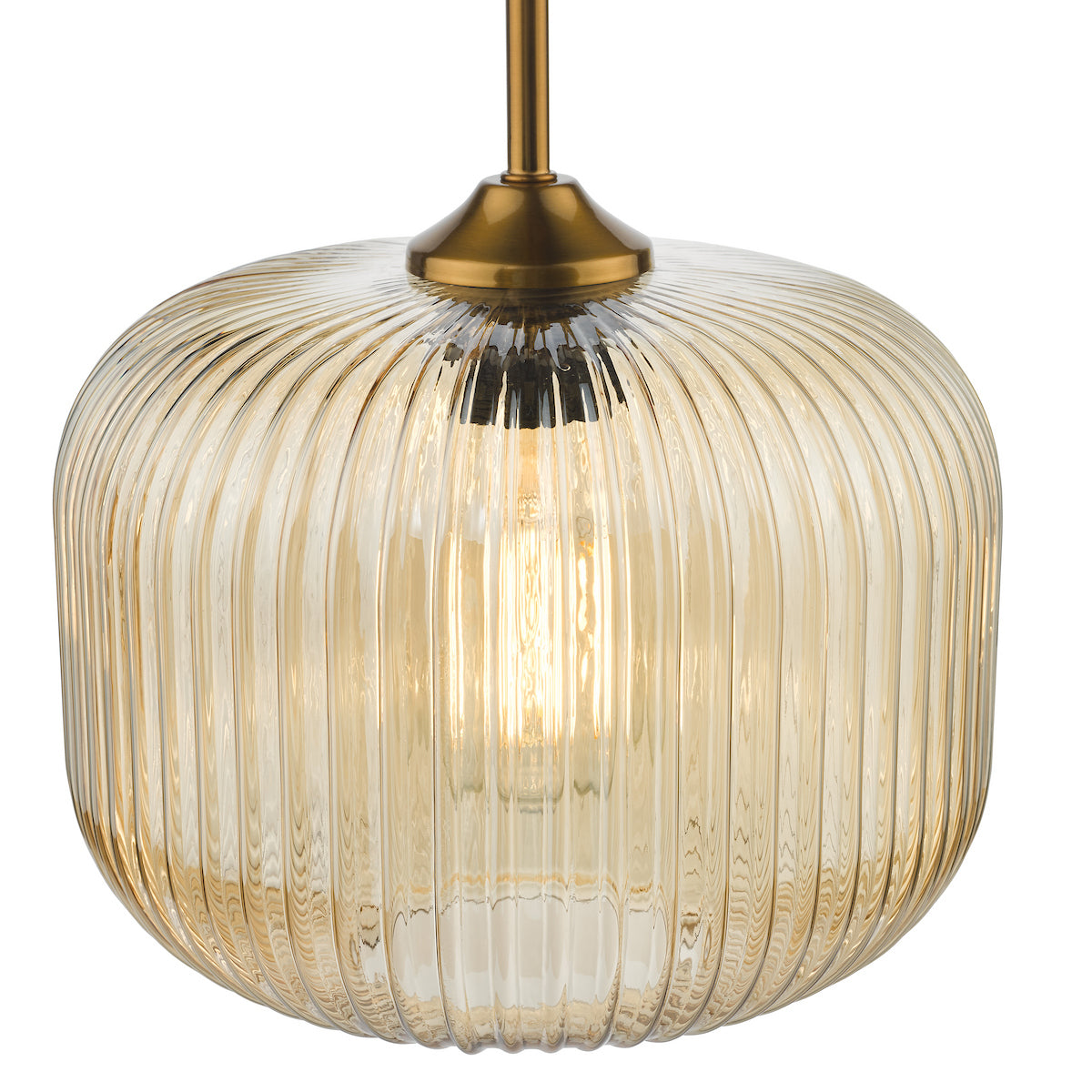 Amber ribbed glass pendant light with a brass fixture and a visible glowing bulb.
