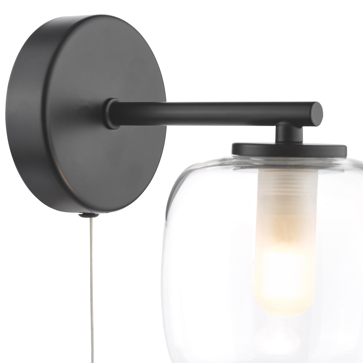Black wall sconce with a clear glass shade and exposed bulb