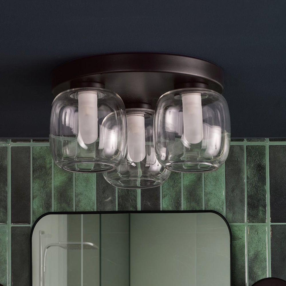 Three light ceiling fixture with clear glass shades and white bulbs