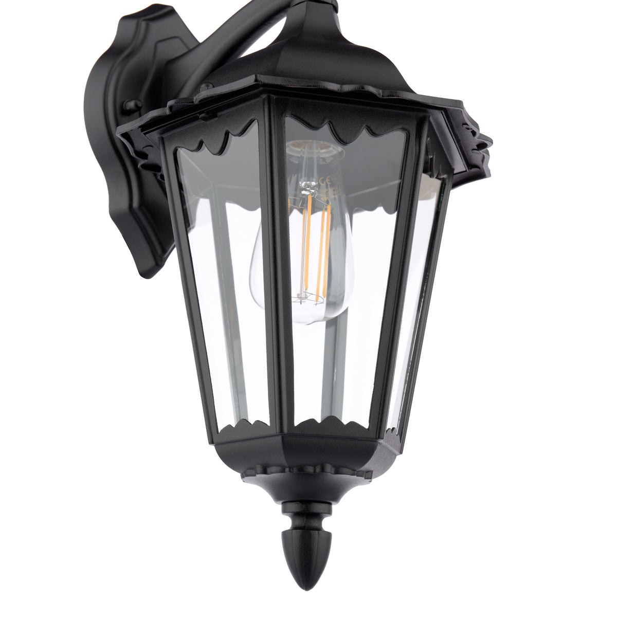 Black outdoor wall lantern with clear glass panels and an exposed filament bulb