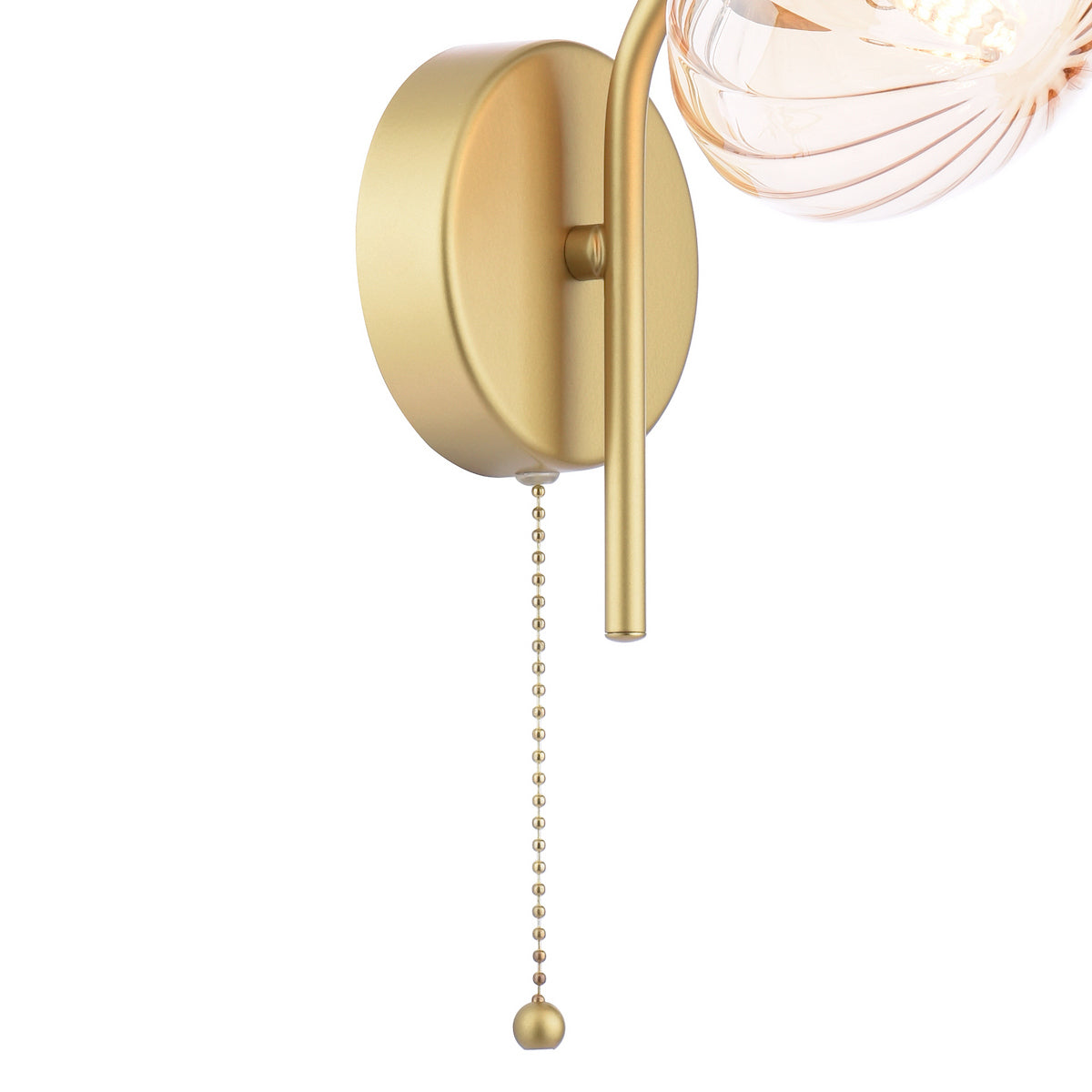Gold wall sconce with a pull chain and a fluted glass shade