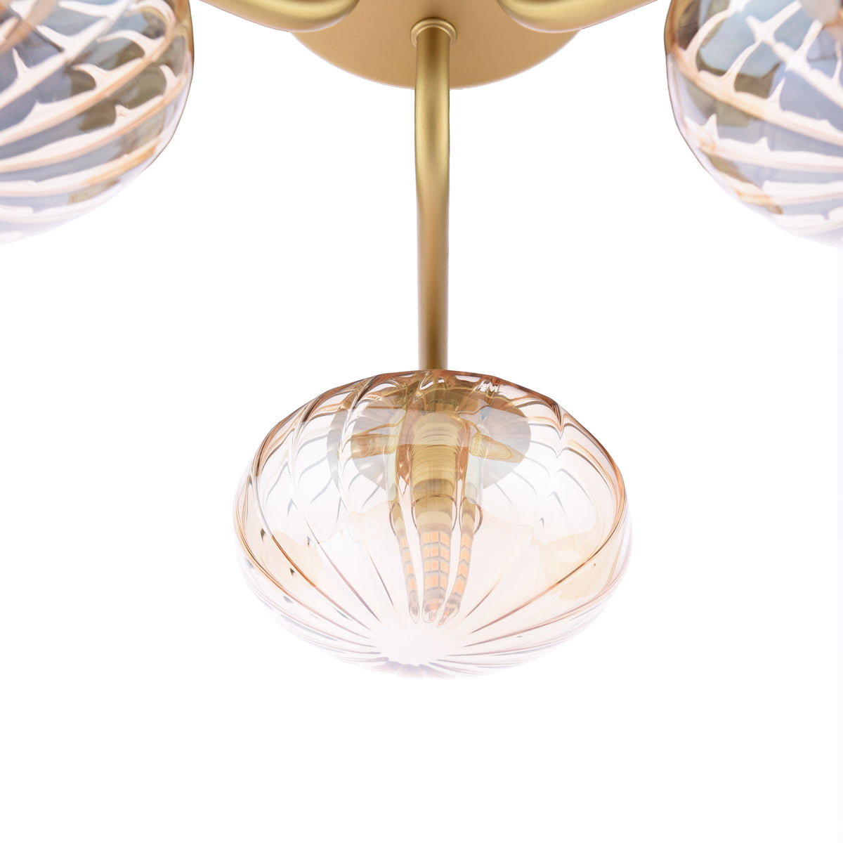 Close-up of a gold chandelier with three amber glass shades, each with a ribbed design
