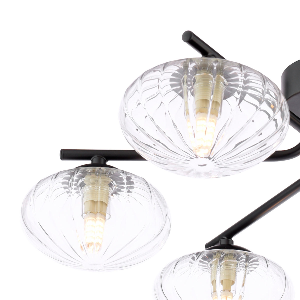 Close up of a black ceiling light with three clear ribbed glass shades