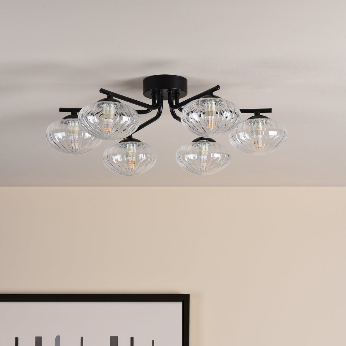 Black metal ceiling light with six clear ribbed glass shades