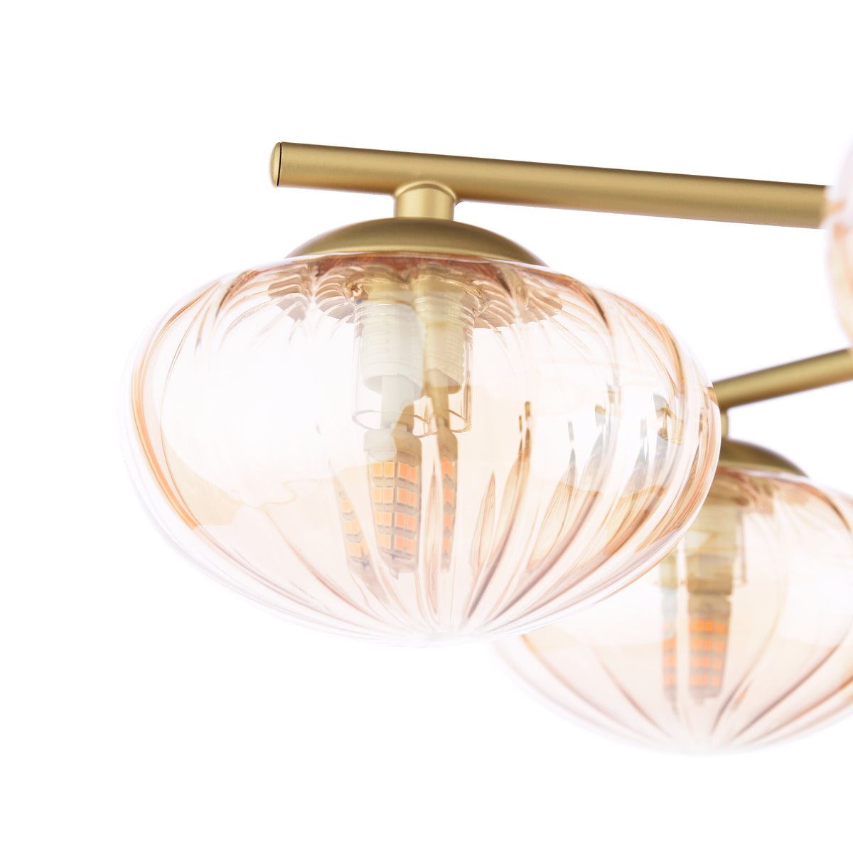 Close up of a gold chandelier with three amber glass shades