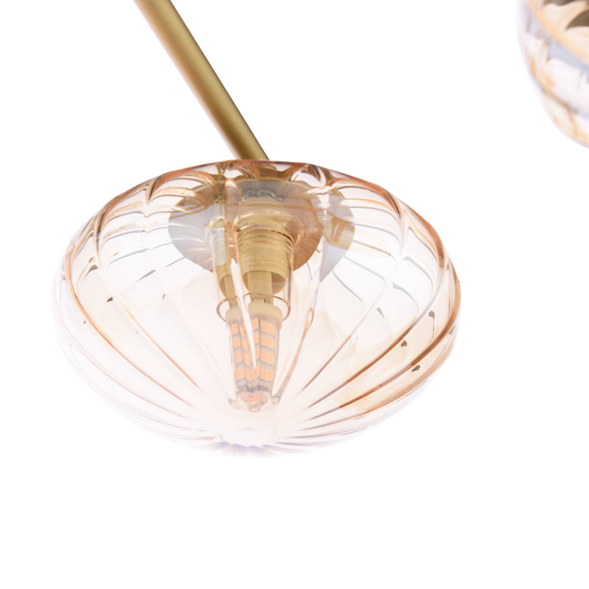 Close-up of a decorative amber glass light fixture with a visible LED bulb inside