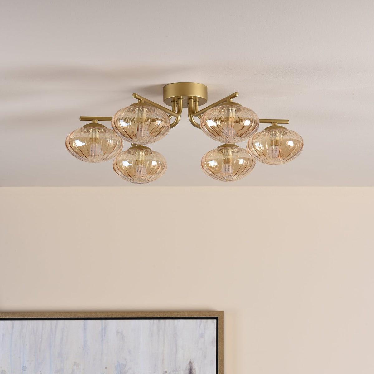 Gold ceiling light with six amber ribbed glass shades