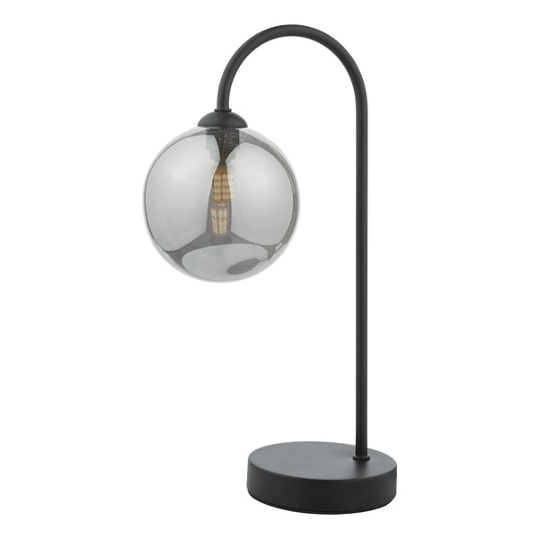 Black metal table lamp with a curved arm and a smoked glass globe shade
