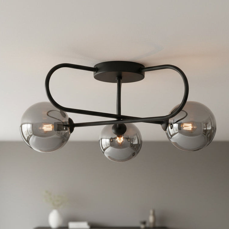 Black ceiling light with three smoked glass globe shades