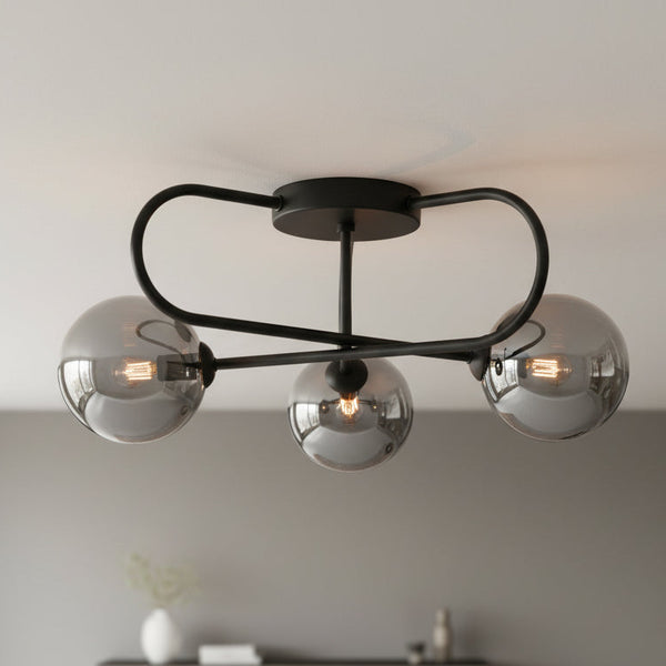 Black ceiling light with three smoked glass globe shades