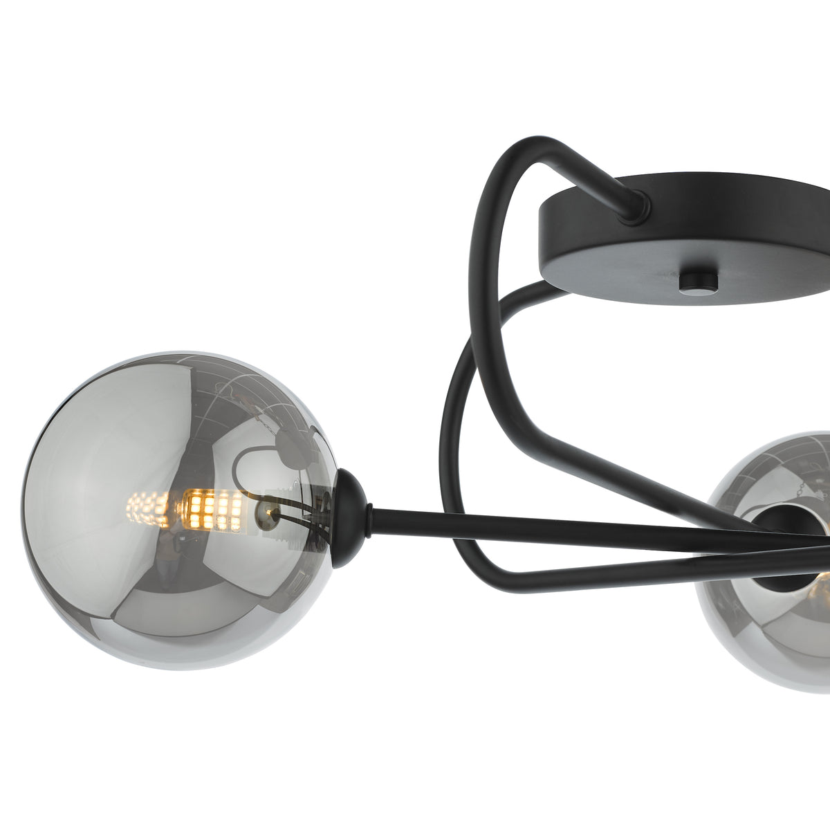 Close up of a black metal chandelier with three smoked glass globes, one with a lit LED bulb