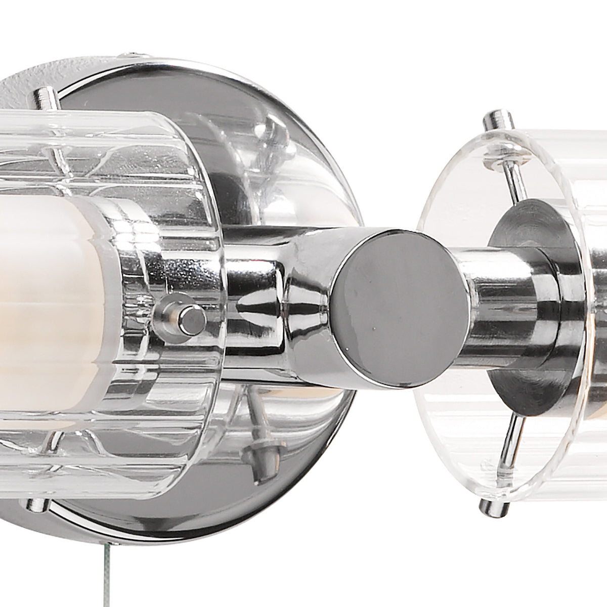 Close-up of a chrome and clear glass light fixture with two bulbs.