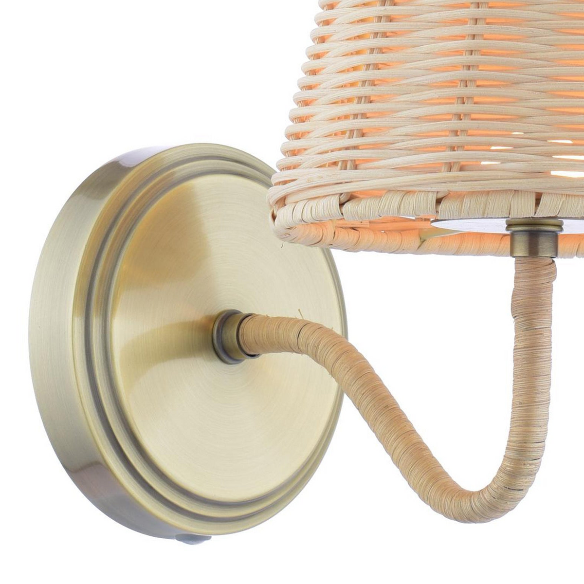 Wall sconce with a brass circular base and a woven rattan lampshade