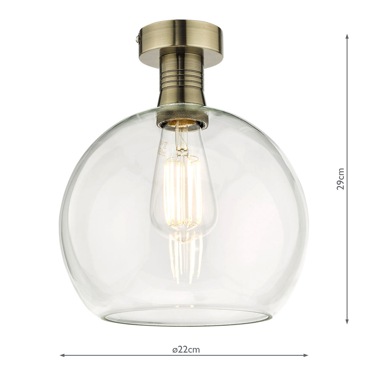 A clear glass dome ceiling light with a brass base and an exposed filament bulb.