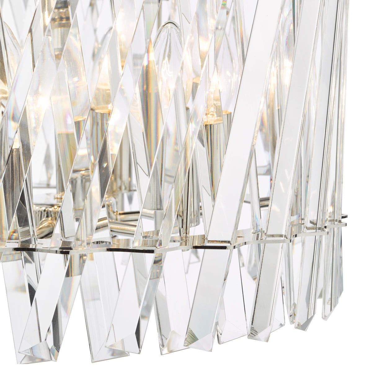 Close up of a crystal chandelier with light bulbs visible through the clear, angled panels