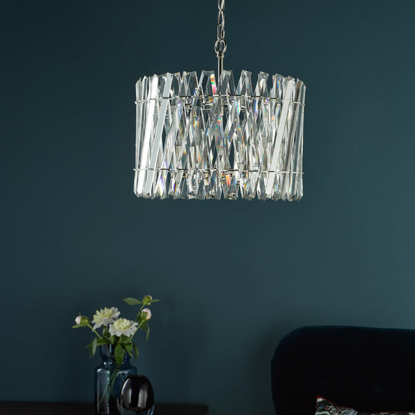 Rectangular crystal chandelier with a dark teal wall background