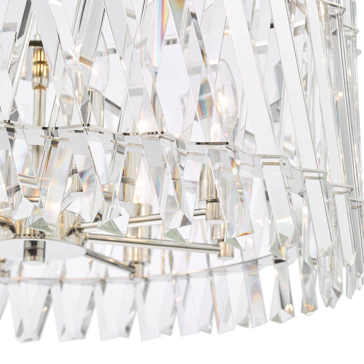 Close up of a crystal chandelier with light bulbs visible through the clear, geometric crystal pieces