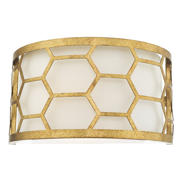 Gold honeycomb pattern wall sconce with a white fabric shade