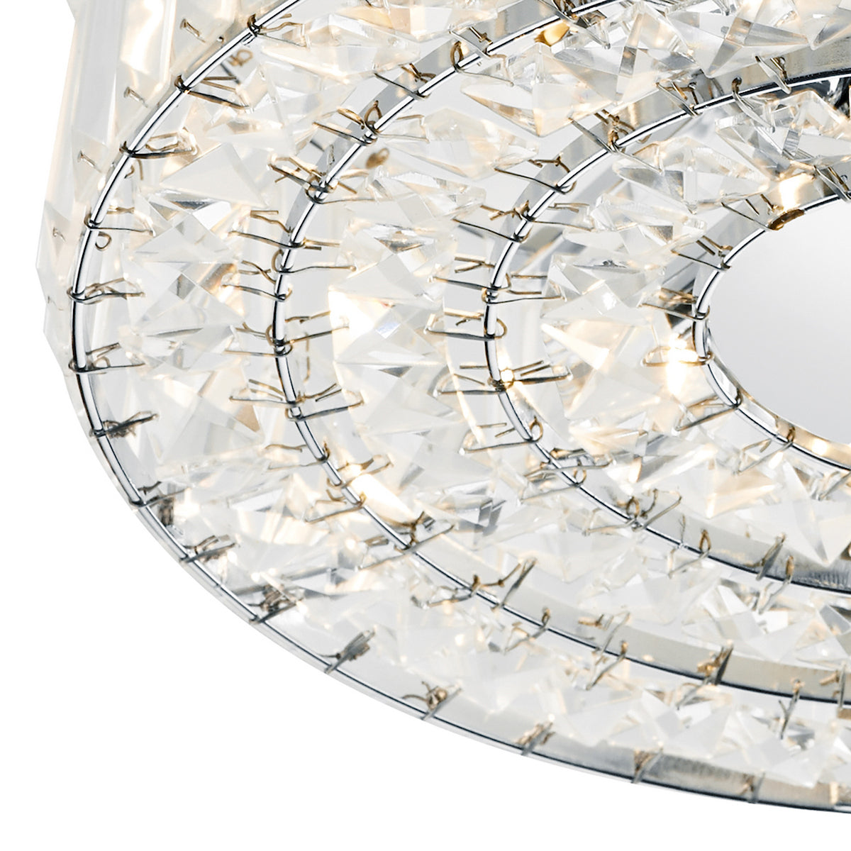 Close-up of a crystal chandelier with multiple tiers of clear, faceted crystals on a metal frame.