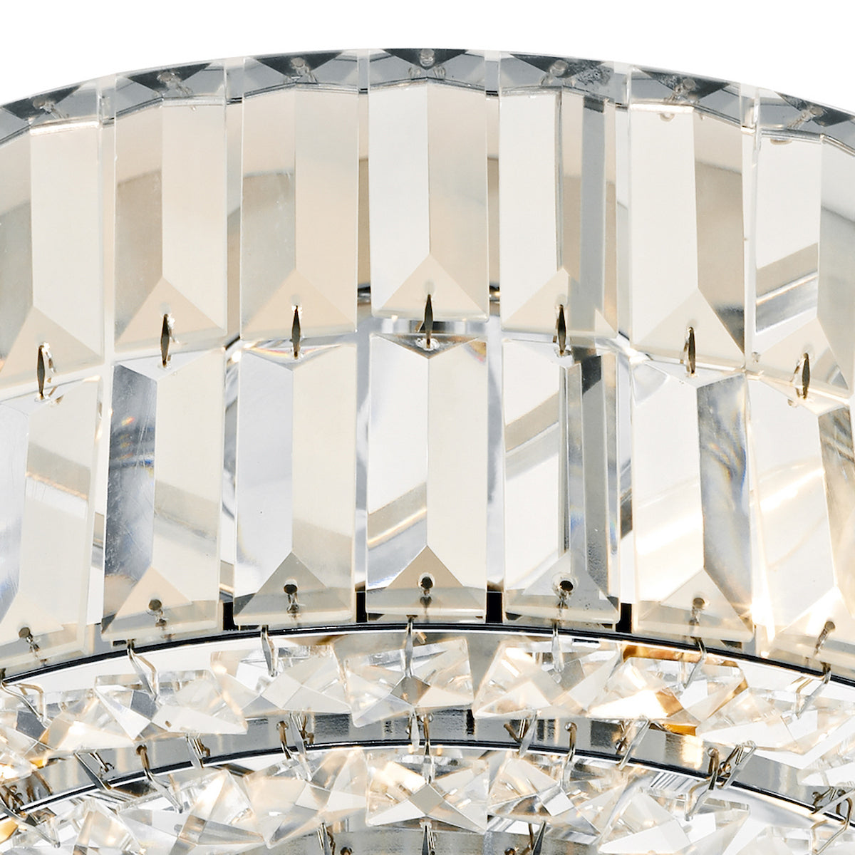 Close-up of a crystal chandelier with rectangular and square prisms reflecting light.