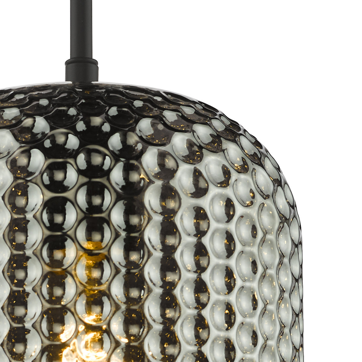 Close up of a black pendant light with a textured glass shade