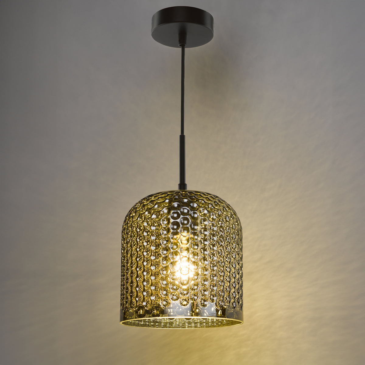 A dark bronze pendant light with a textured, amber-colored glass shade