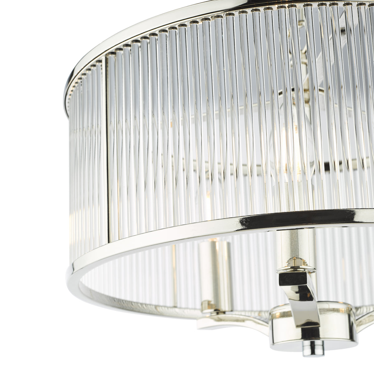 Close-up of a polished nickel chandelier with a cylindrical shade made of clear glass rods