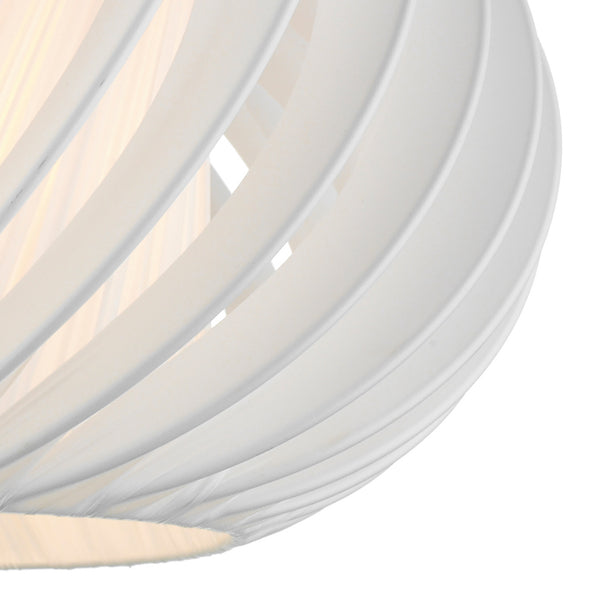 Close-up of a white, spiraled lampshade with light glowing from within.
