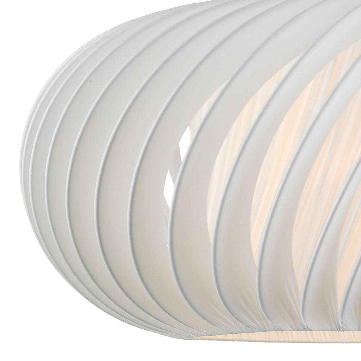 Close-up of a white, ribbed light fixture with warm light glowing from within.