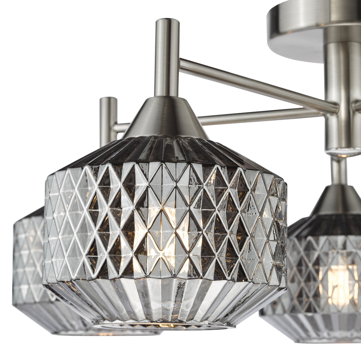 Close up of a brushed nickel chandelier with three lights, each with a textured glass shade
