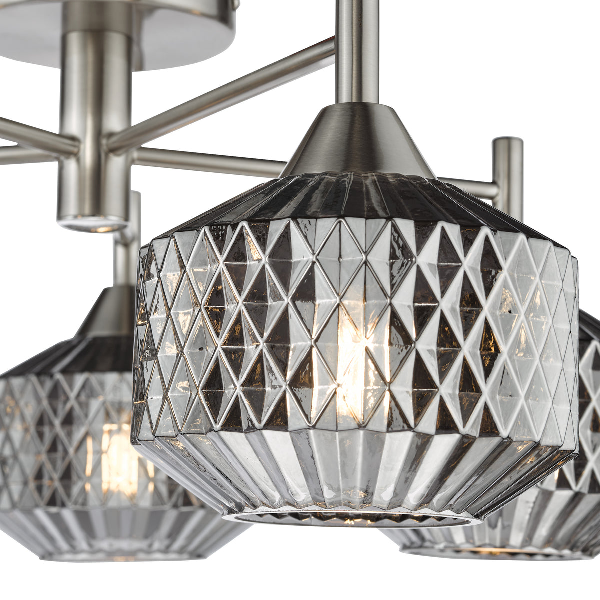 Close up of a modern chandelier with three lights, each with a textured glass shade and a brushed nickel finish