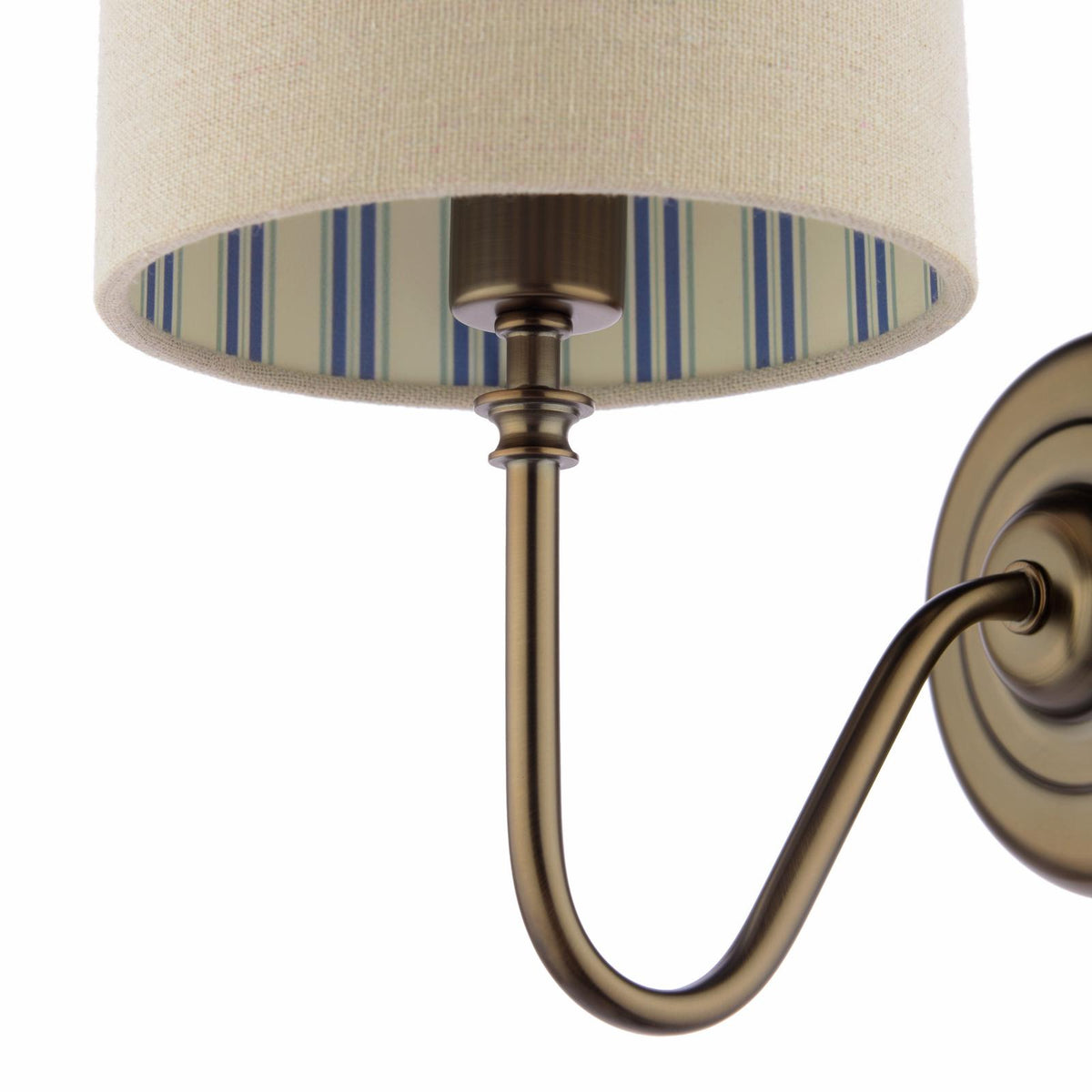 Joules Farley wall light in satin bronze with a natural linen shade featuring a blue striped interior
