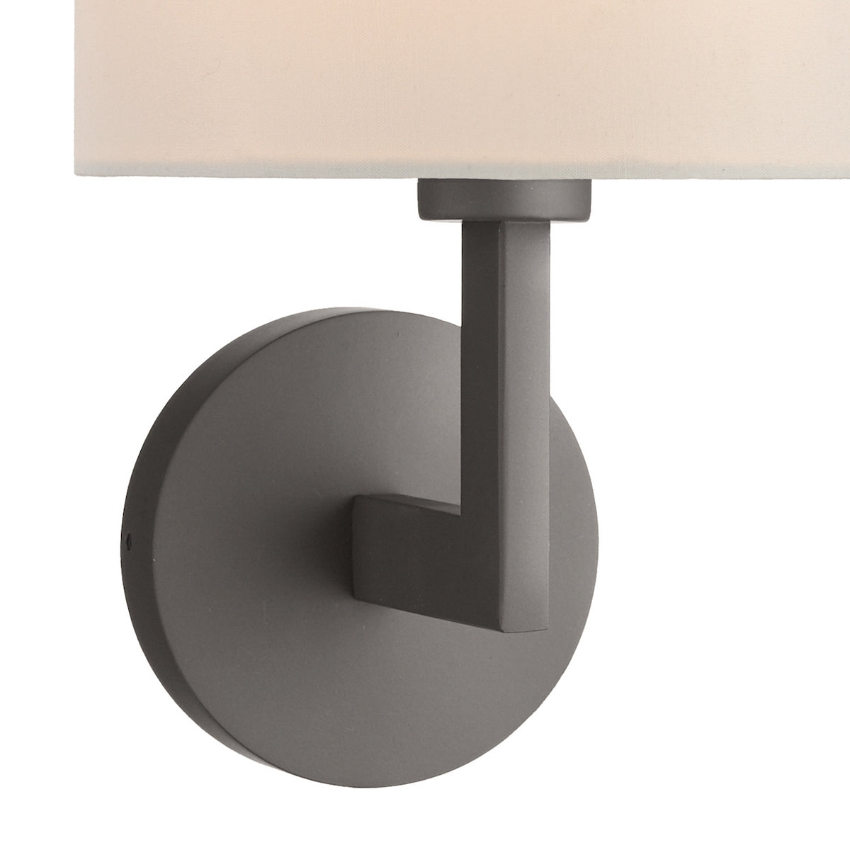Close-up of a dark gray wall sconce with a white fabric shade, mounted on a white background.