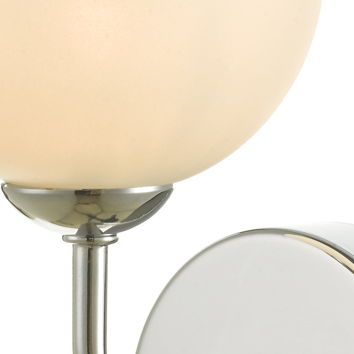 Close-up of a light fixture with a frosted glass globe and polished chrome base.