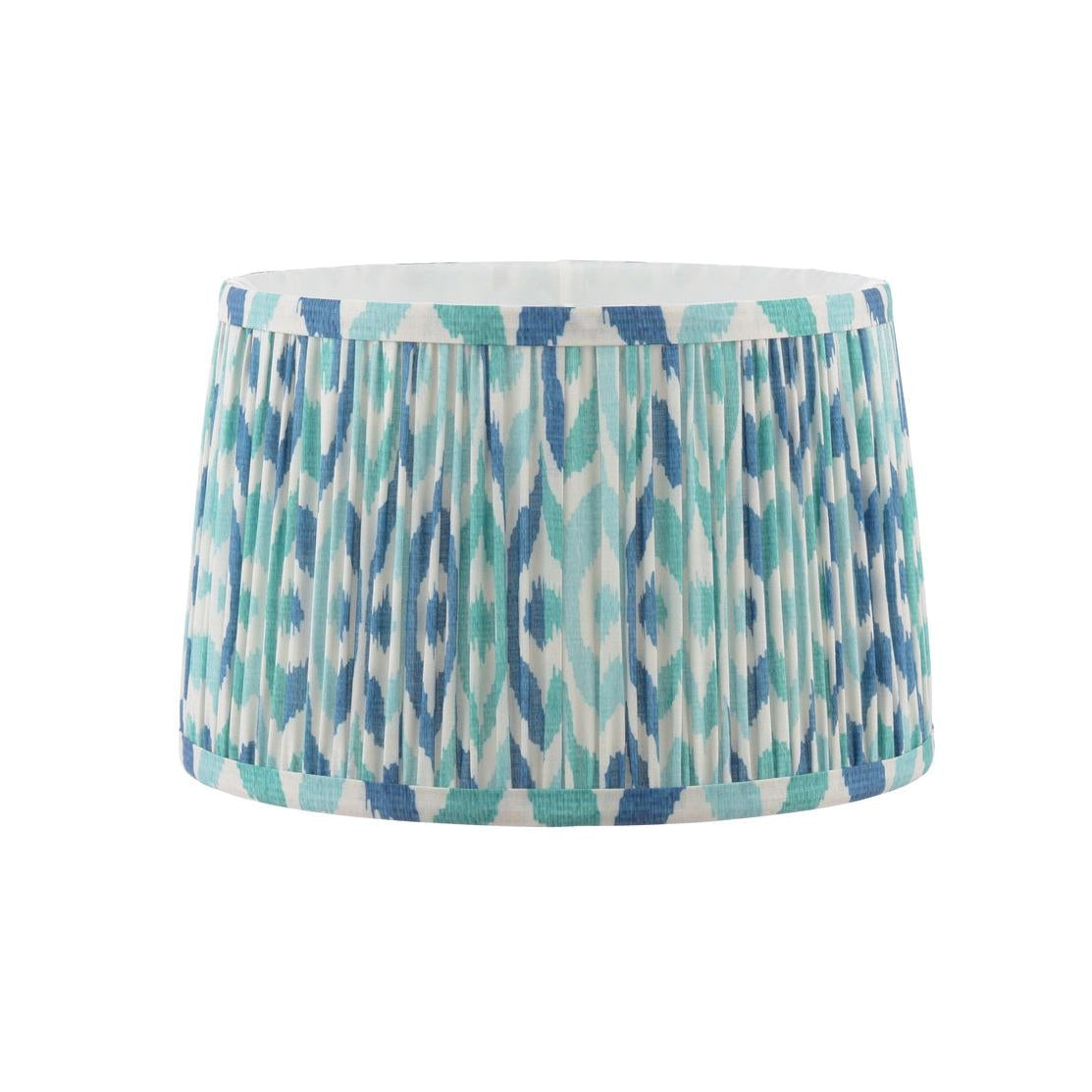 Drum lampshade with blue and teal ikat pattern and pleated fabric