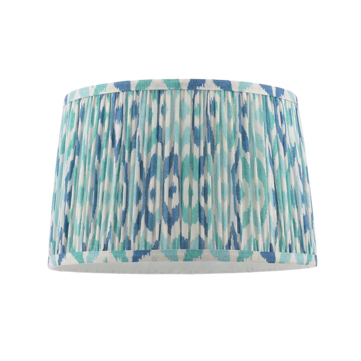 Drum lampshade with blue and teal ikat pattern and pleated fabric texture