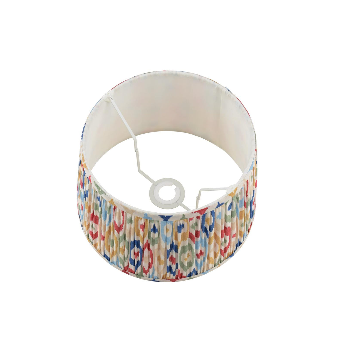 Round pleated lampshade with a colorful ikat pattern on a white background