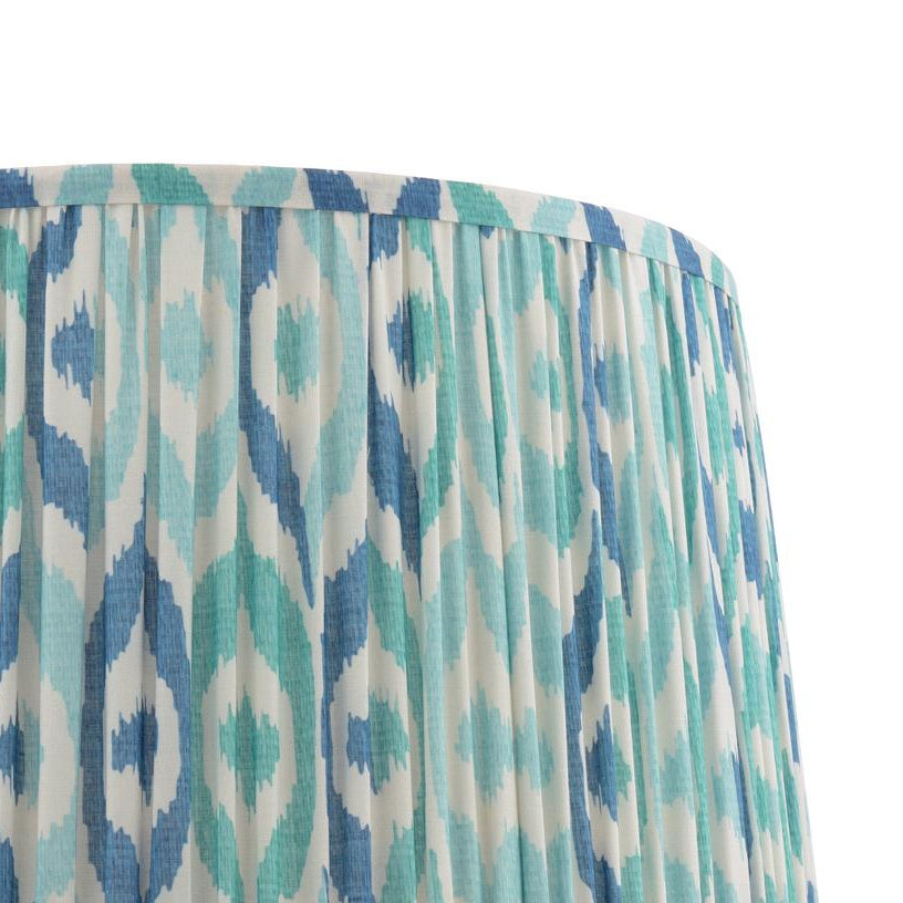 Pleated drum lampshade with blue and teal ikat pattern