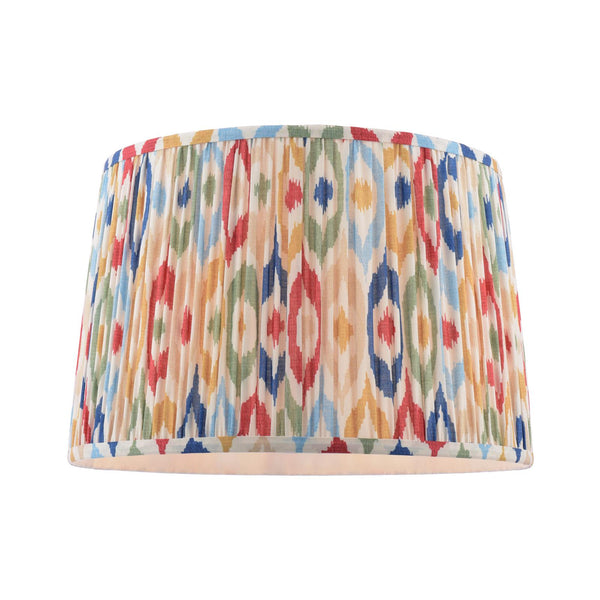 Drum lampshade with a pleated fabric texture and a colorful ikat geometric pattern