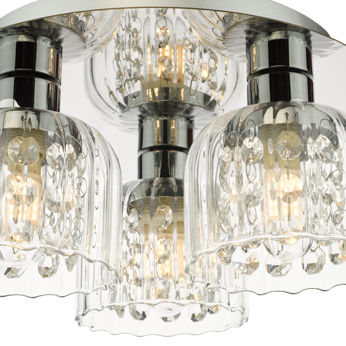Close up of a three light ceiling fixture with clear glass shades and crystal accents