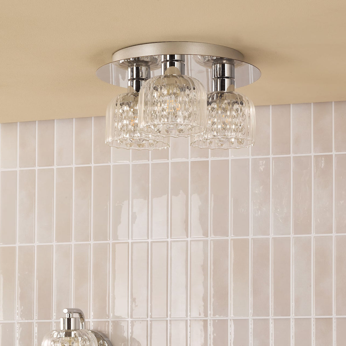 Three light ceiling fixture with clear glass shades and chrome accents