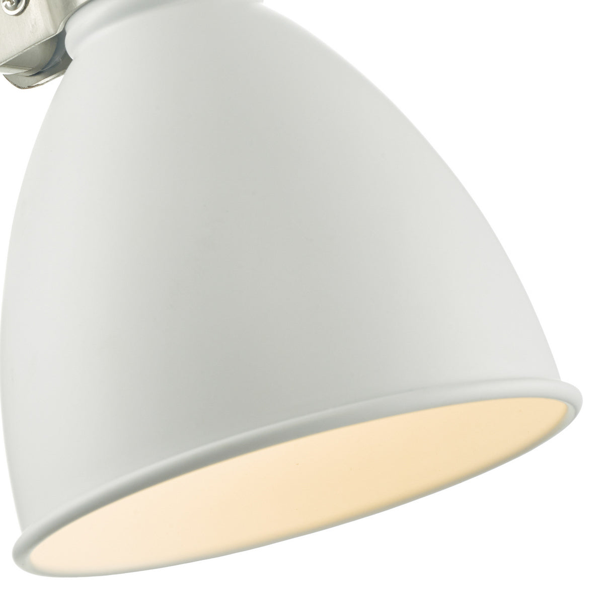 Close up of a white light shade with a warm glow