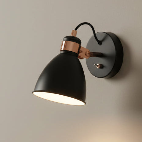 Black and copper wall light with a conical shade and a toggle switch