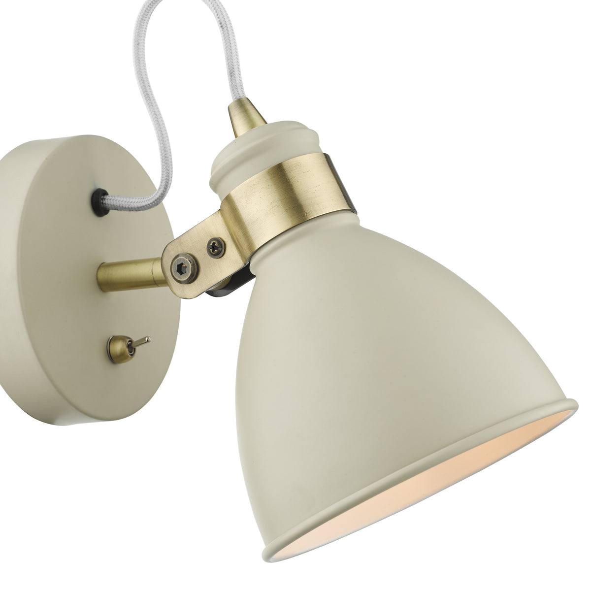 Cream wall light with brass accents and a white braided cord