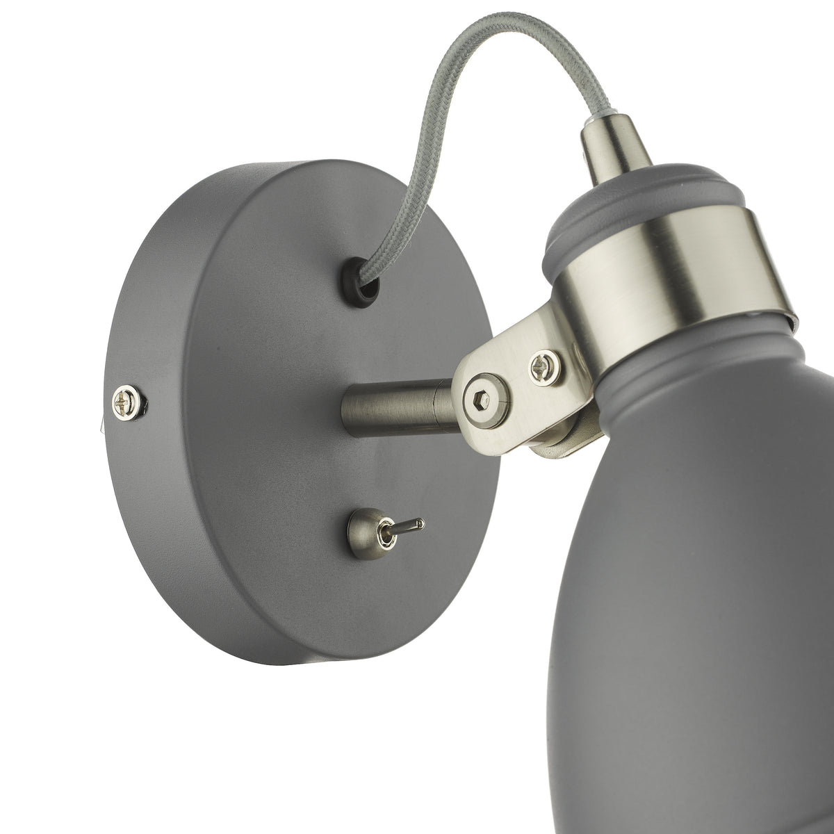 Close up of a grey wall light with a toggle switch and a flexible grey braided cable