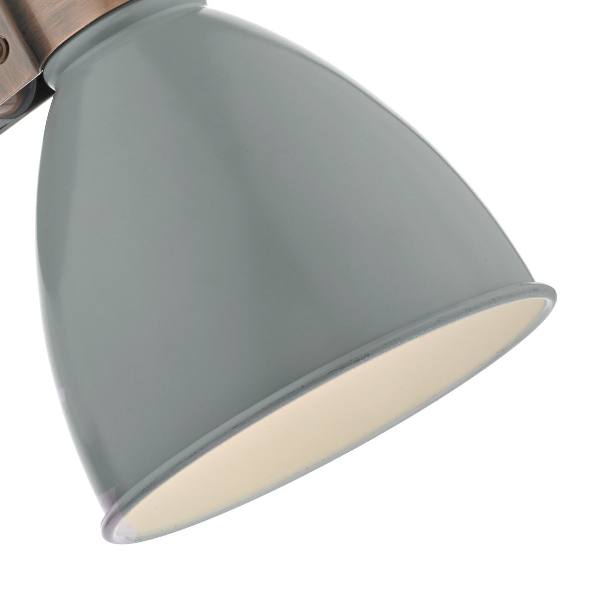 Close up of a grey metal lamp shade with a copper fitting