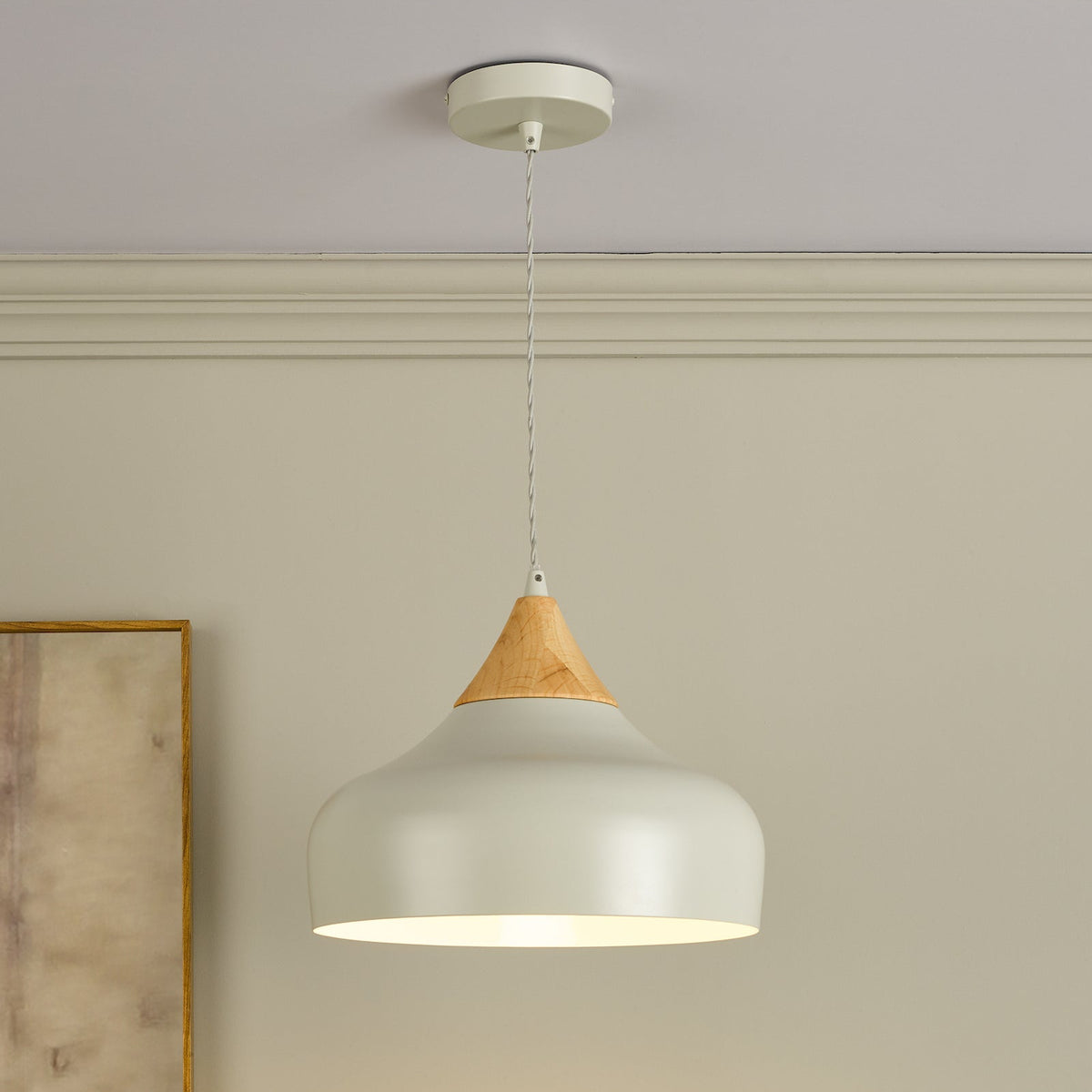 White pendant light with a wooden top hanging from a ceiling