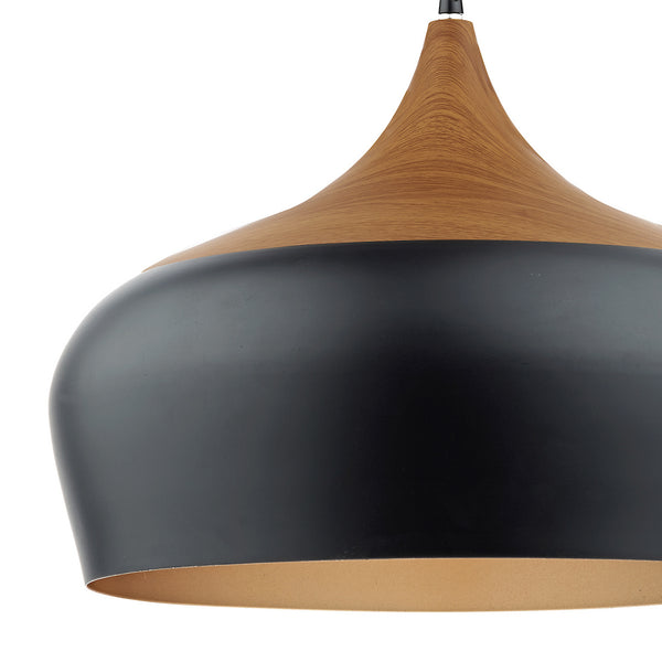 Black and wood pendant light with a golden interior.