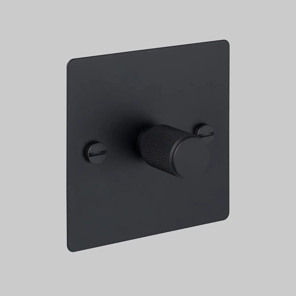 Black dimmer switch with a textured knob and two visible screws